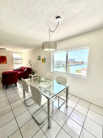 a living room with furniture a flat screen tv and a window