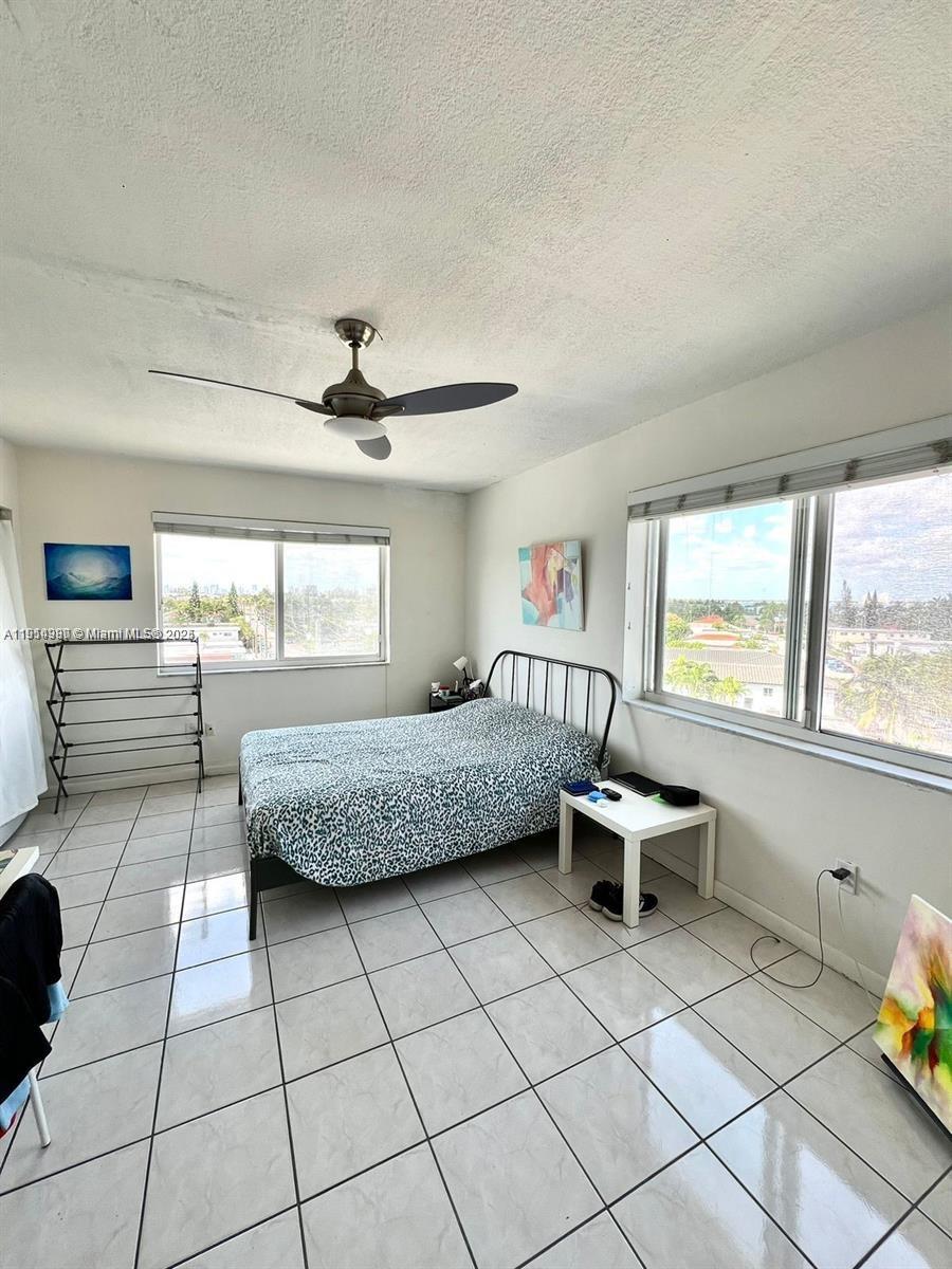 8001 Crespi Boulevard, Unit 6D Miami Beach, FL 33141 - Photo 15 of 29 a living room with furniture and a window