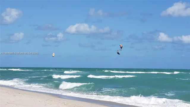 a white bench sitting in front of a house