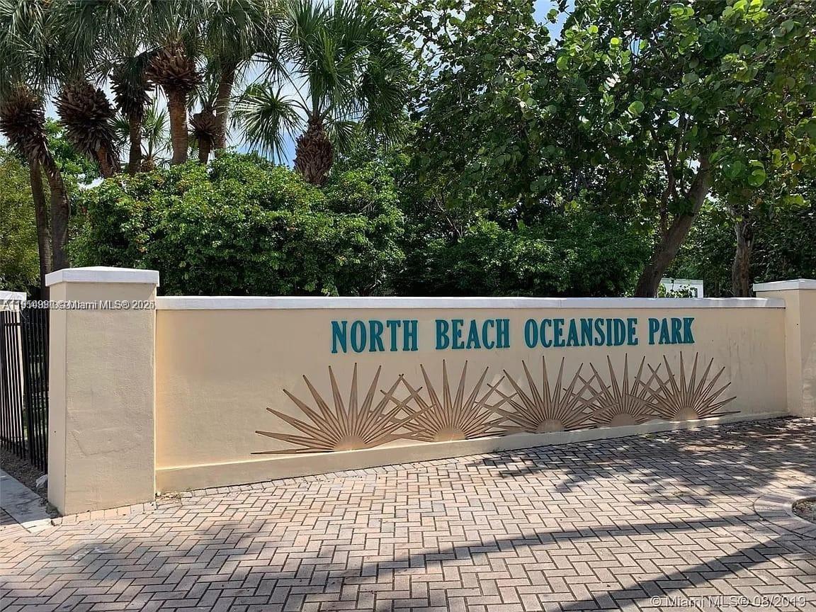 8001 Crespi Boulevard, Unit 6D Miami Beach, FL 33141 - Photo 23 of 29 a white bench sitting in front of a house
