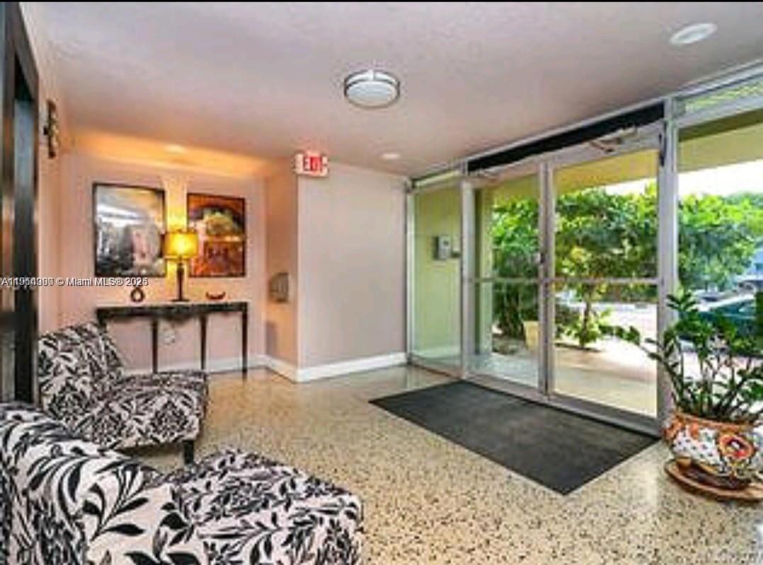 8001 Crespi Boulevard, Unit 6D Miami Beach, FL 33141 - Photo 29 of 29 a living room with furniture and a potted plant