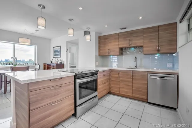 a kitchen with granite countertop cabinets stainless steel appliances and a sink