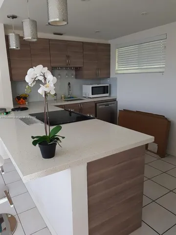a kitchen with a sink and white cabinets