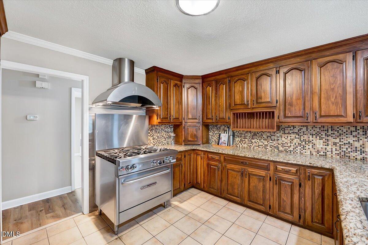 2805 Mary Marvin Trail Willow Spring, NC 27592 - Photo 11 of 33 a kitchen with granite countertop a stove sink and cabinets