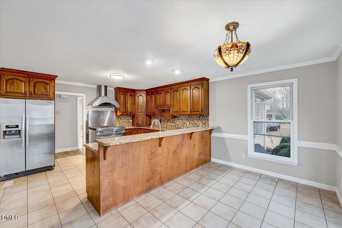 2805 Mary Marvin Trail Willow Spring, NC 27592 - Photo 12 of 33 a kitchen with stainless steel appliances granite countertop a stove a sink and a refrigerator