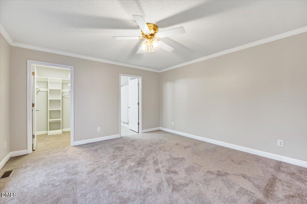2805 Mary Marvin Trail Willow Spring, NC 27592 - Photo 19 of 33 an empty room with closet and a ceiling fan