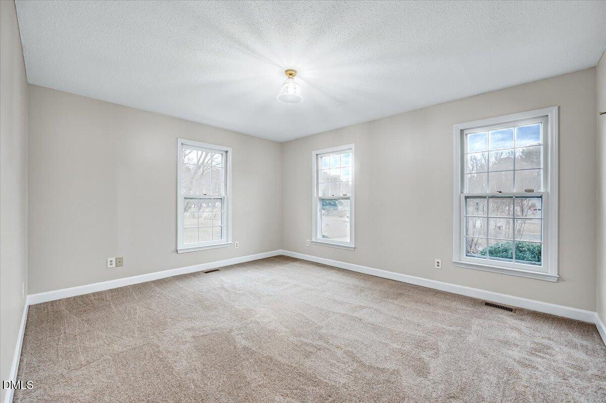 2805 Mary Marvin Trail Willow Spring, NC 27592 - Photo 22 of 33 an empty room with windows and closet