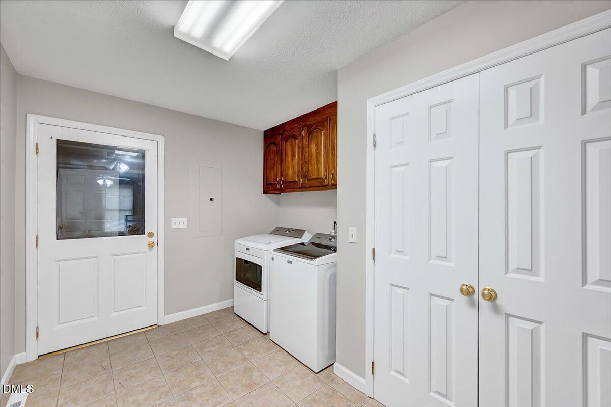 2805 Mary Marvin Trail Willow Spring, NC 27592 - Photo 25 of 33 a kitchen with a stove and white cabinets