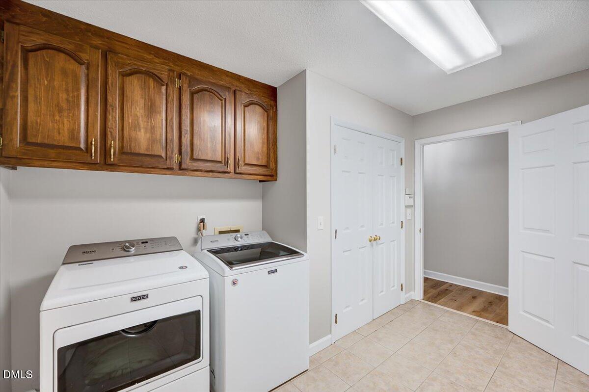 2805 Mary Marvin Trail Willow Spring, NC 27592 - Photo 26 of 33 a view of a storage and utility room with washer and dryer