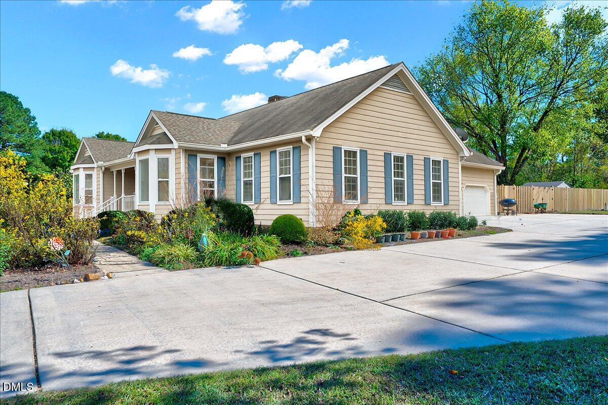 2805 Mary Marvin Trail Willow Spring, NC 27592 - Photo 3 of 33 a front view of a house with a garden