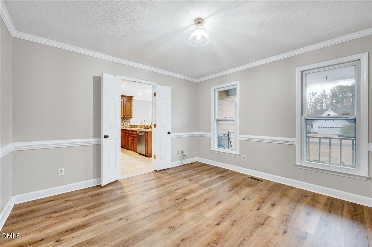 2805 Mary Marvin Trail Willow Spring, NC 27592 - Photo 6 of 33 wooden floor in an empty room with a window