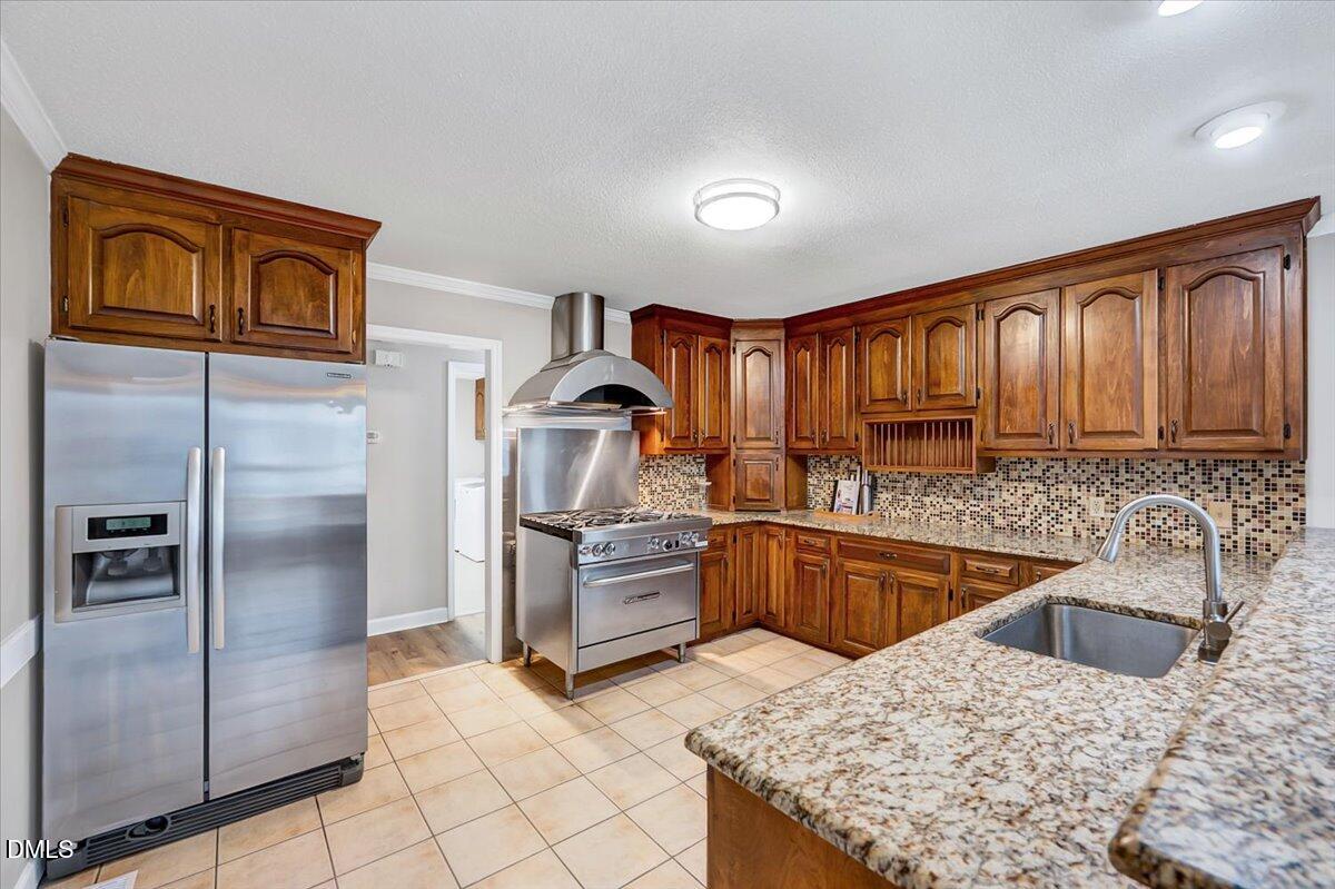 2805 Mary Marvin Trail Willow Spring, NC 27592 - Photo 10 of 33 a kitchen with stainless steel appliances granite countertop a refrigerator sink and stove