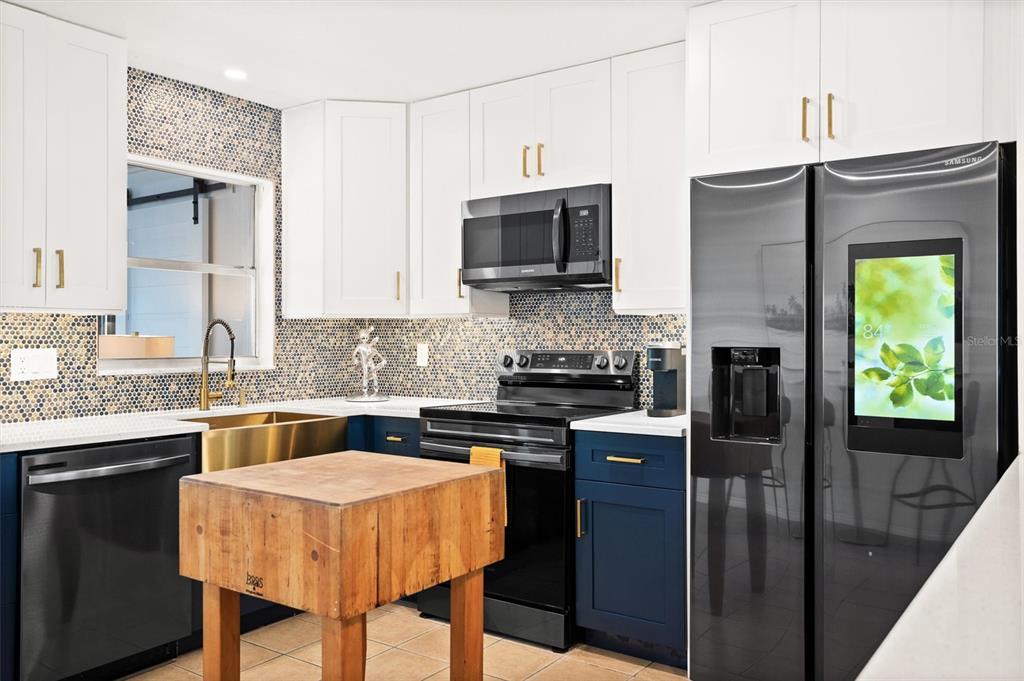 3488 40th Way North St. Petersburg, FL 33713 - Photo 11 of 70 a kitchen with stainless steel appliances granite countertop a stove refrigerator sink and cabinets