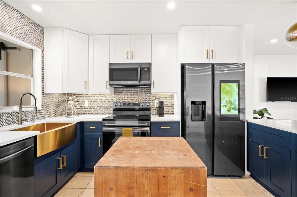 3488 40th Way North St. Petersburg, FL 33713 - Photo 12 of 70 a kitchen with stainless steel appliances kitchen island granite countertop a refrigerator stove and sink