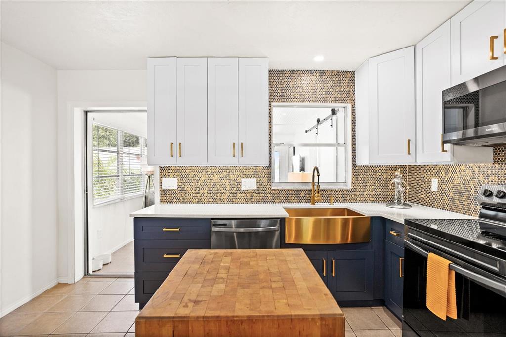 3488 40th Way North St. Petersburg, FL 33713 - Photo 14 of 70 a kitchen with stainless steel appliances granite countertop a sink stove and microwave