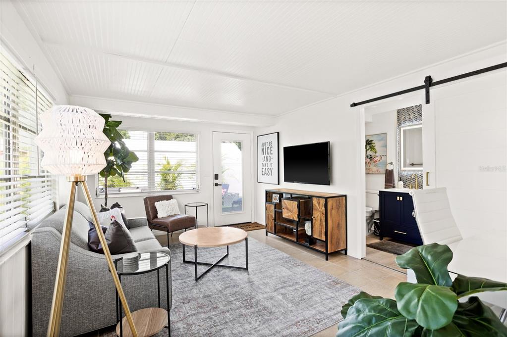 3488 40th Way North St. Petersburg, FL 33713 - Photo 17 of 70 a living room with furniture a flat screen tv and a fireplace