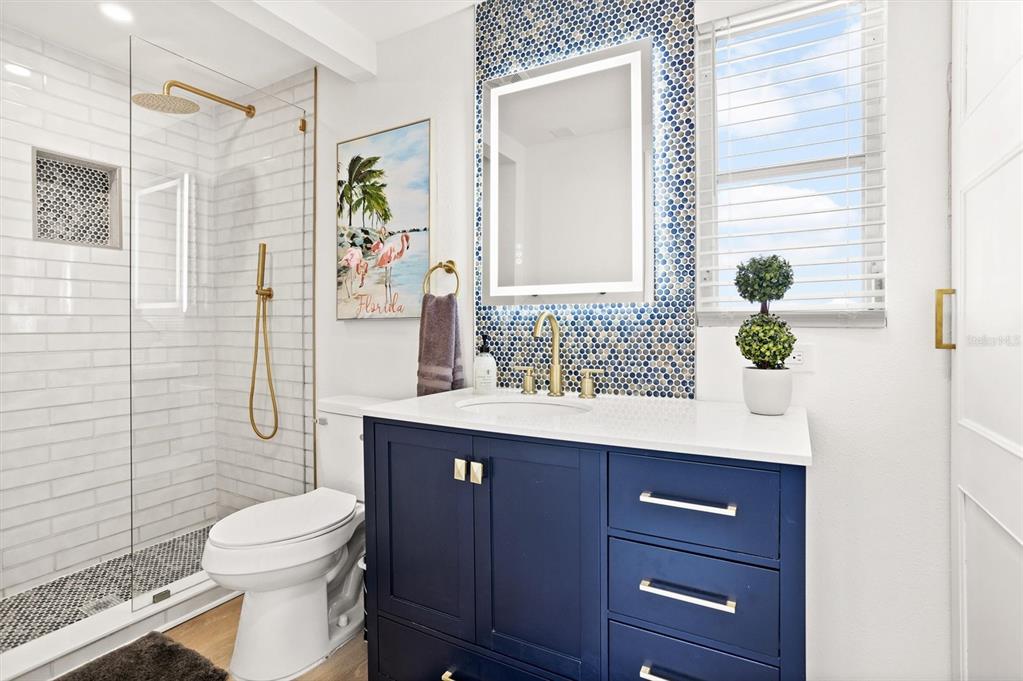 3488 40th Way North St. Petersburg, FL 33713 - Photo 27 of 70 a bathroom with a sink a toilet and shower