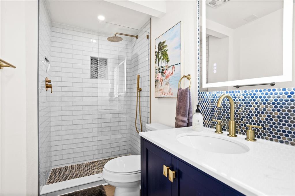 3488 40th Way North St. Petersburg, FL 33713 - Photo 28 of 70 a bathroom with a sink toilet and shower