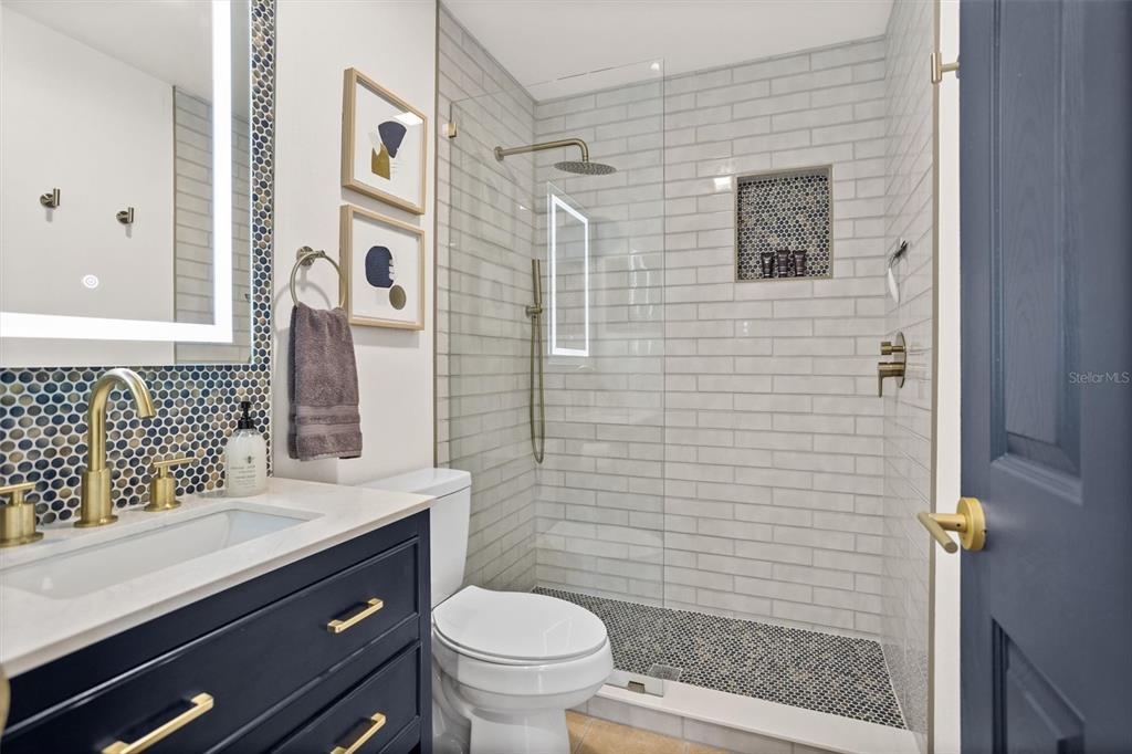 3488 40th Way North St. Petersburg, FL 33713 - Photo 41 of 70 a bathroom with a sink a toilet and shower