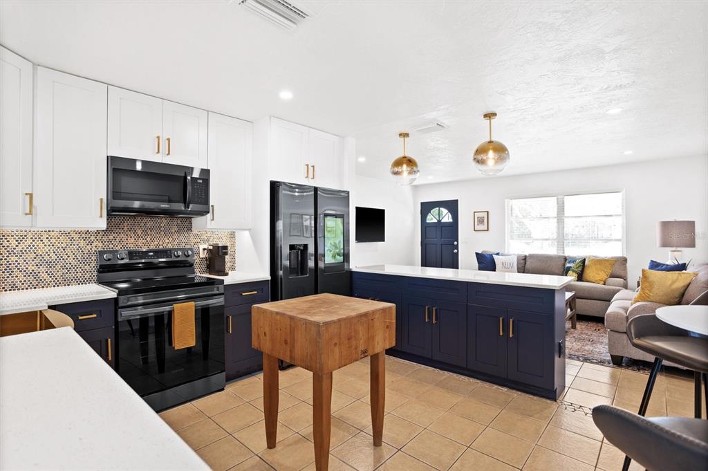 3488 40th Way North St. Petersburg, FL 33713 - Photo 9 of 70 a kitchen with stainless steel appliances kitchen island granite countertop a sink and cabinets
