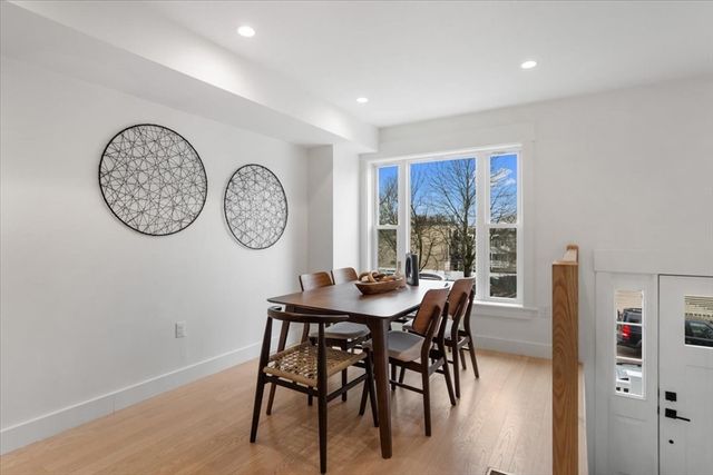 a view of a dining room with furniture window and a wooden floor