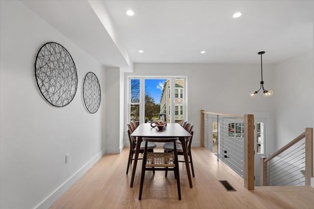 a view of a dining room with furniture and a large window
