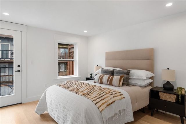a bedroom with a bed and wooden floor