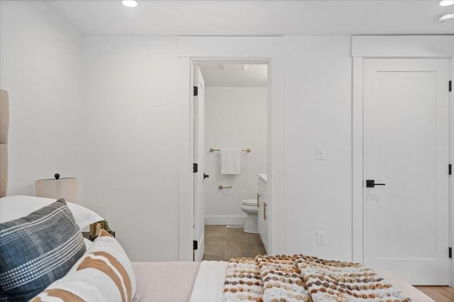 a bedroom with a bed and a sink