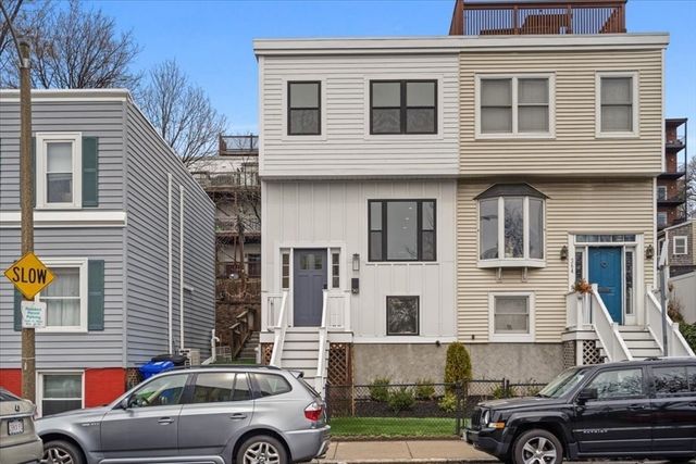 a front view of a house with parking space