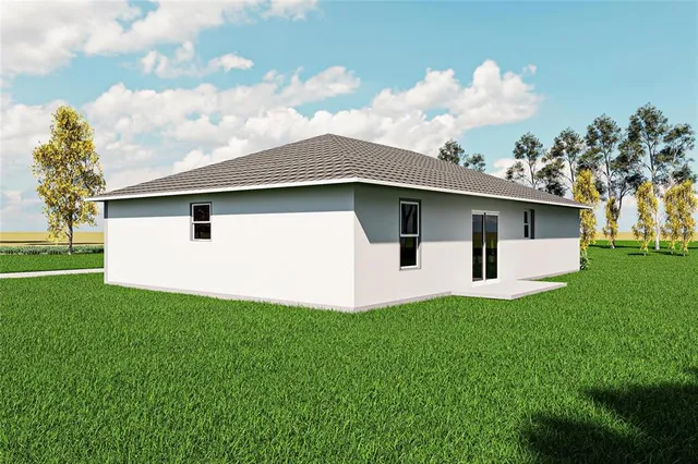 a white house with a small yard and big trees