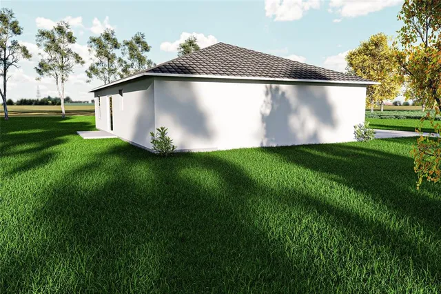 a white house with green field in front of it