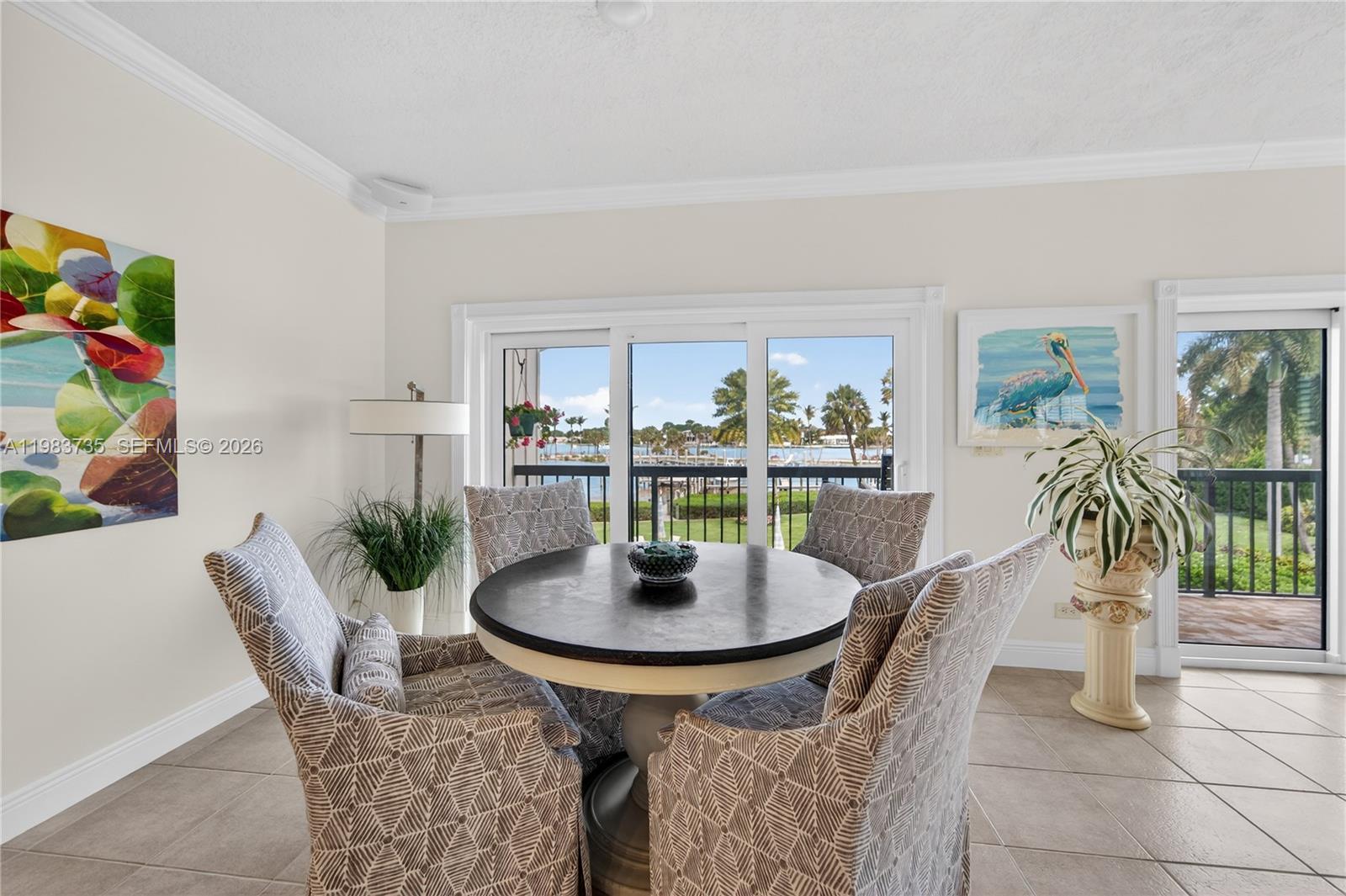 851 Saturn Street, Unit D Jupiter, FL 33477 - Photo 14 of 60 a dining room with furniture and a floor to ceiling window