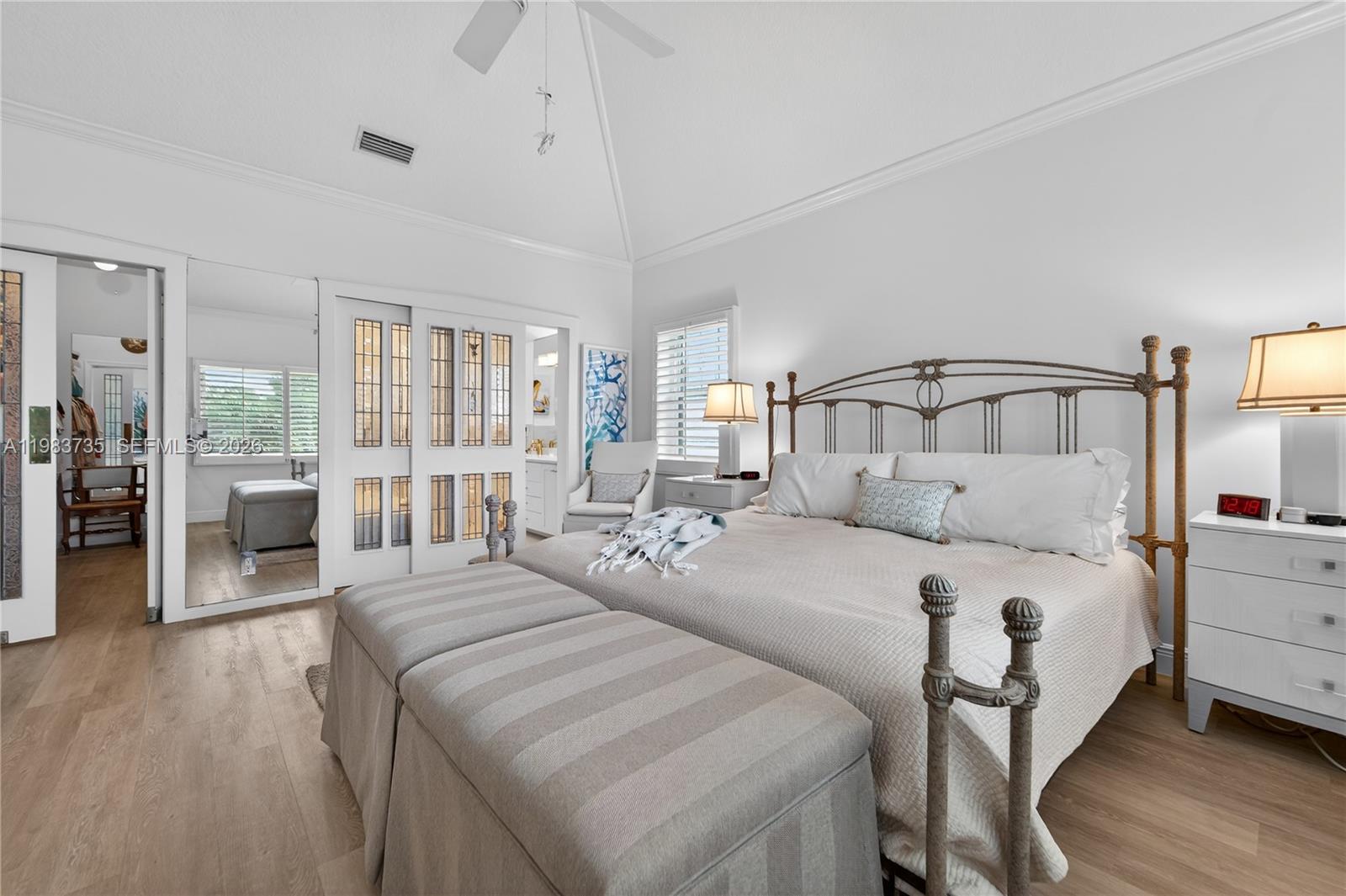 851 Saturn Street, Unit D Jupiter, FL 33477 - Photo 16 of 60 a bedroom with a large bed and a wooden floor