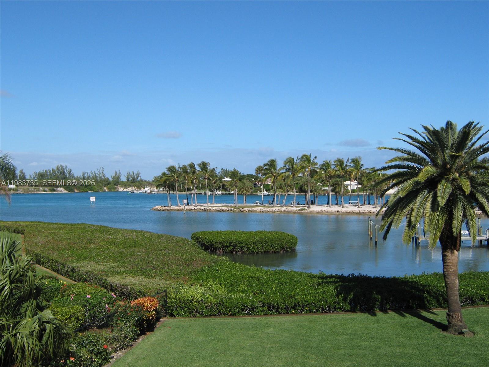 851 Saturn Street, Unit D Jupiter, FL 33477 - Photo 28 of 60 a view of a lake with houses in the back