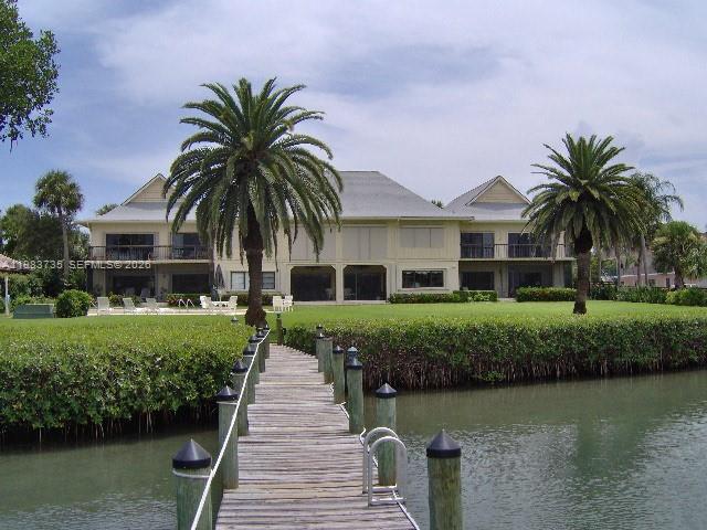 851 Saturn Street, Unit D Jupiter, FL 33477 - Photo 36 of 60 a front view of a house with a garden and lake view