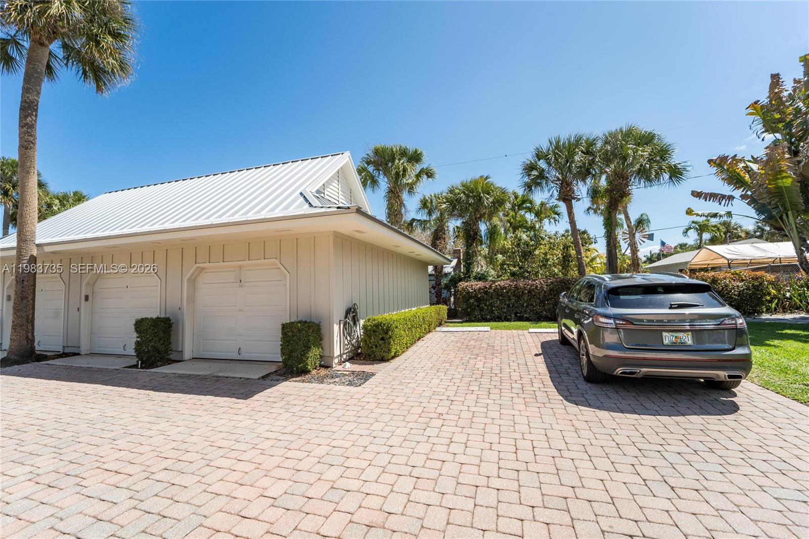 851 Saturn Street, Unit D Jupiter, FL 33477 - Photo 46 of 60 a view of a car parked in front of a building