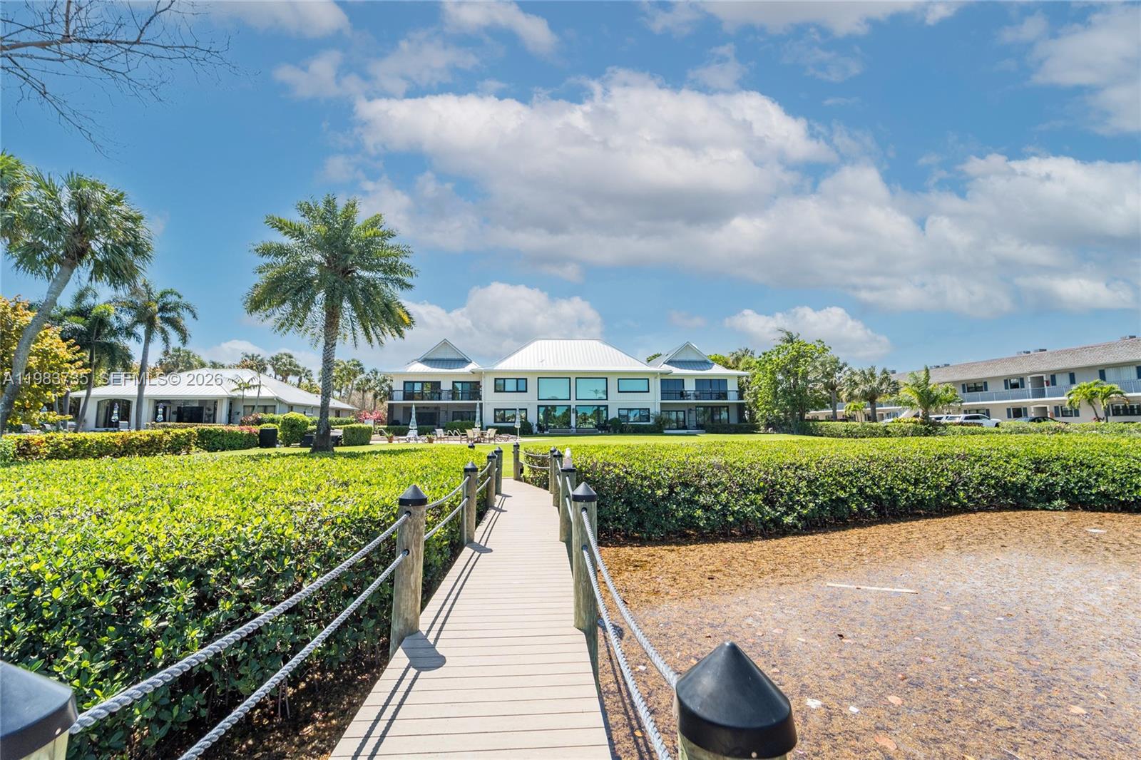851 Saturn Street, Unit D Jupiter, FL 33477 - Photo 54 of 60 a view of a swimming pool and trees in the background