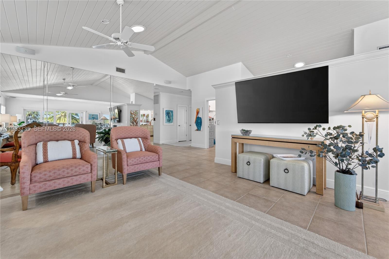 851 Saturn Street, Unit D Jupiter, FL 33477 - Photo 9 of 60 a living room with furniture and a flat screen tv