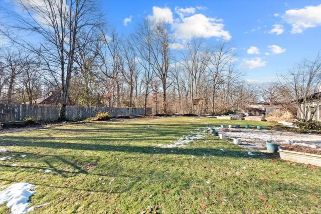 a swimming pool with outdoor seating and yard