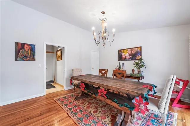 a dining room with furniture and a potted plant