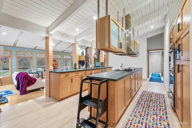 a living room with furniture a flat screen tv and a floor to ceiling window
