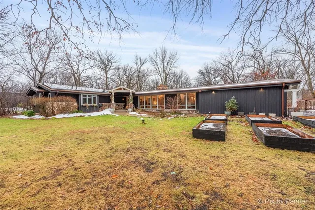 a view of a house with swimming pool and sitting area