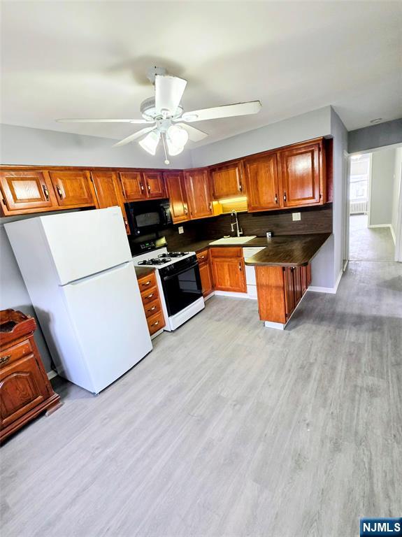 245 Beech Street, Unit 2 Kearny, NJ 07032 - Photo 2 of 16 a living room with furniture a flat screen tv and kitchen view
