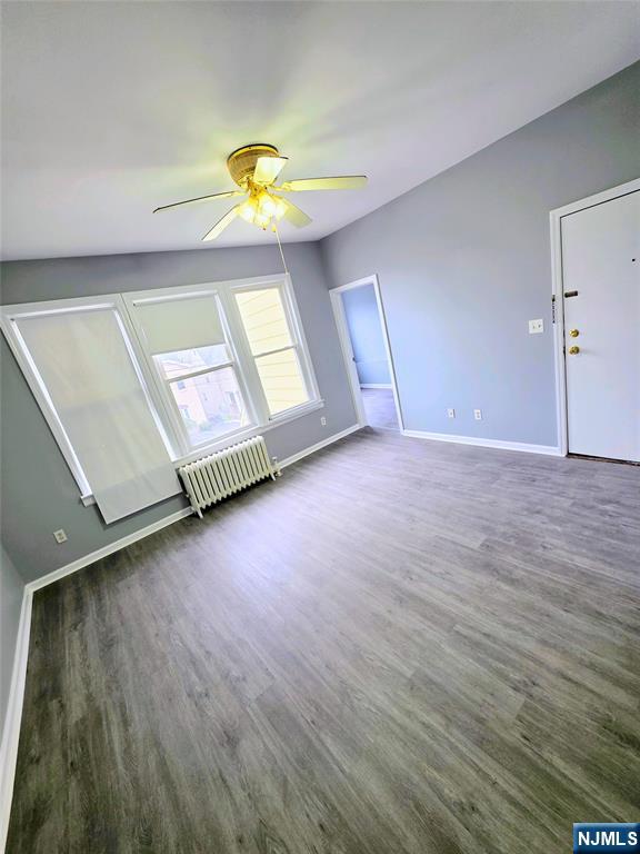 245 Beech Street, Unit 2 Kearny, NJ 07032 - Photo 4 of 16 a view of an empty room with window and wooden floor
