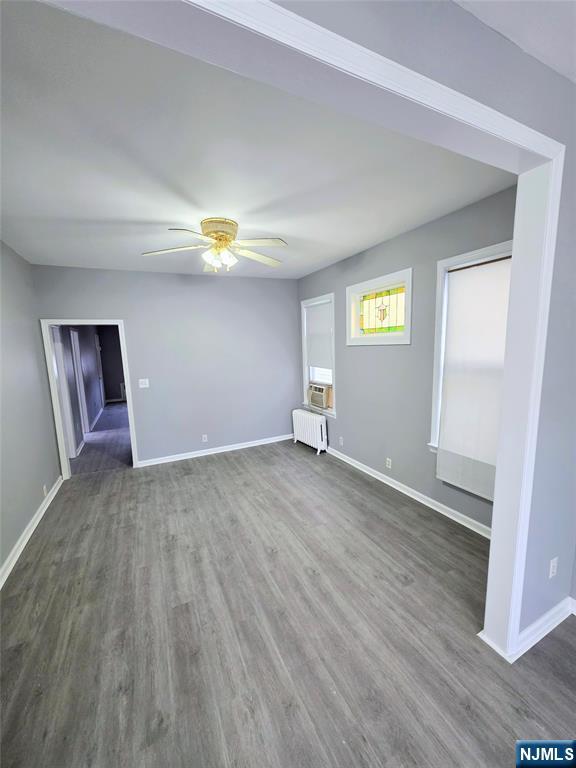 245 Beech Street, Unit 2 Kearny, NJ 07032 - Photo 5 of 16 an empty room with wooden floor and windows