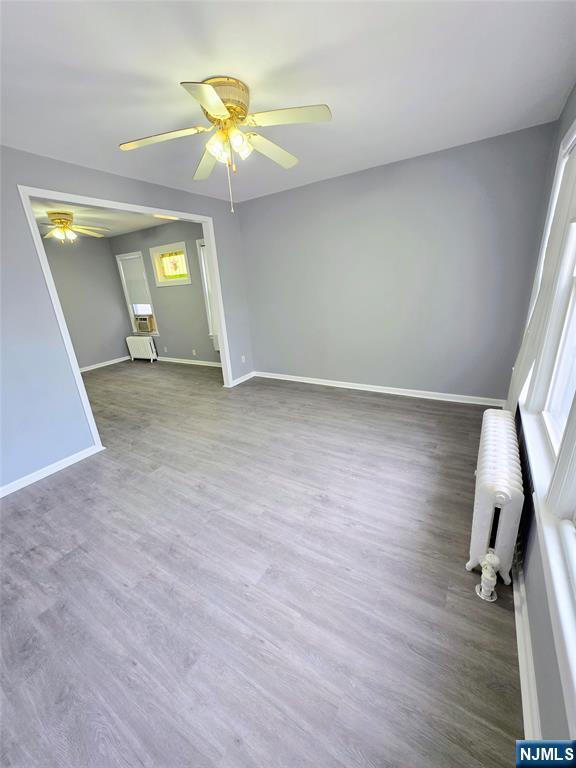 245 Beech Street, Unit 2 Kearny, NJ 07032 - Photo 6 of 16 wooden floor in an empty room with a window