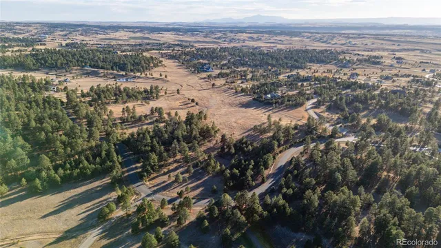 an aerial view of residential houses with city view