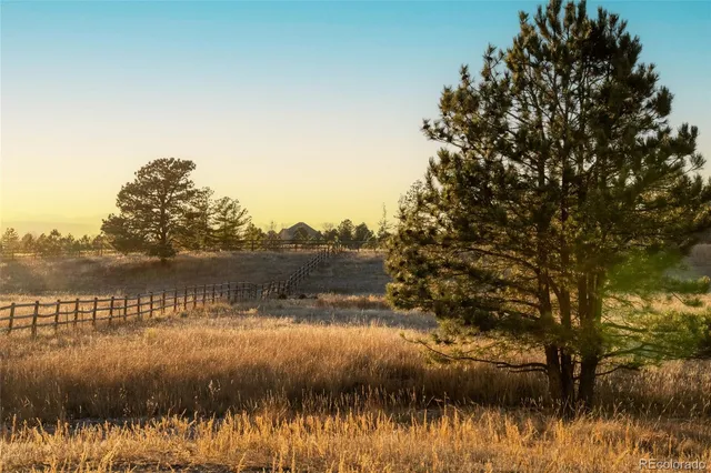 a view of lake with green landscape