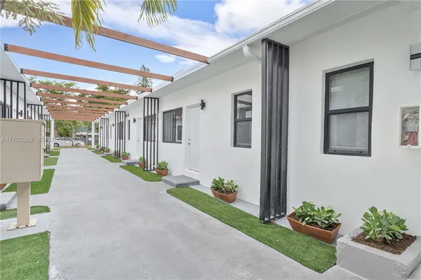a view of a porch with potted plants