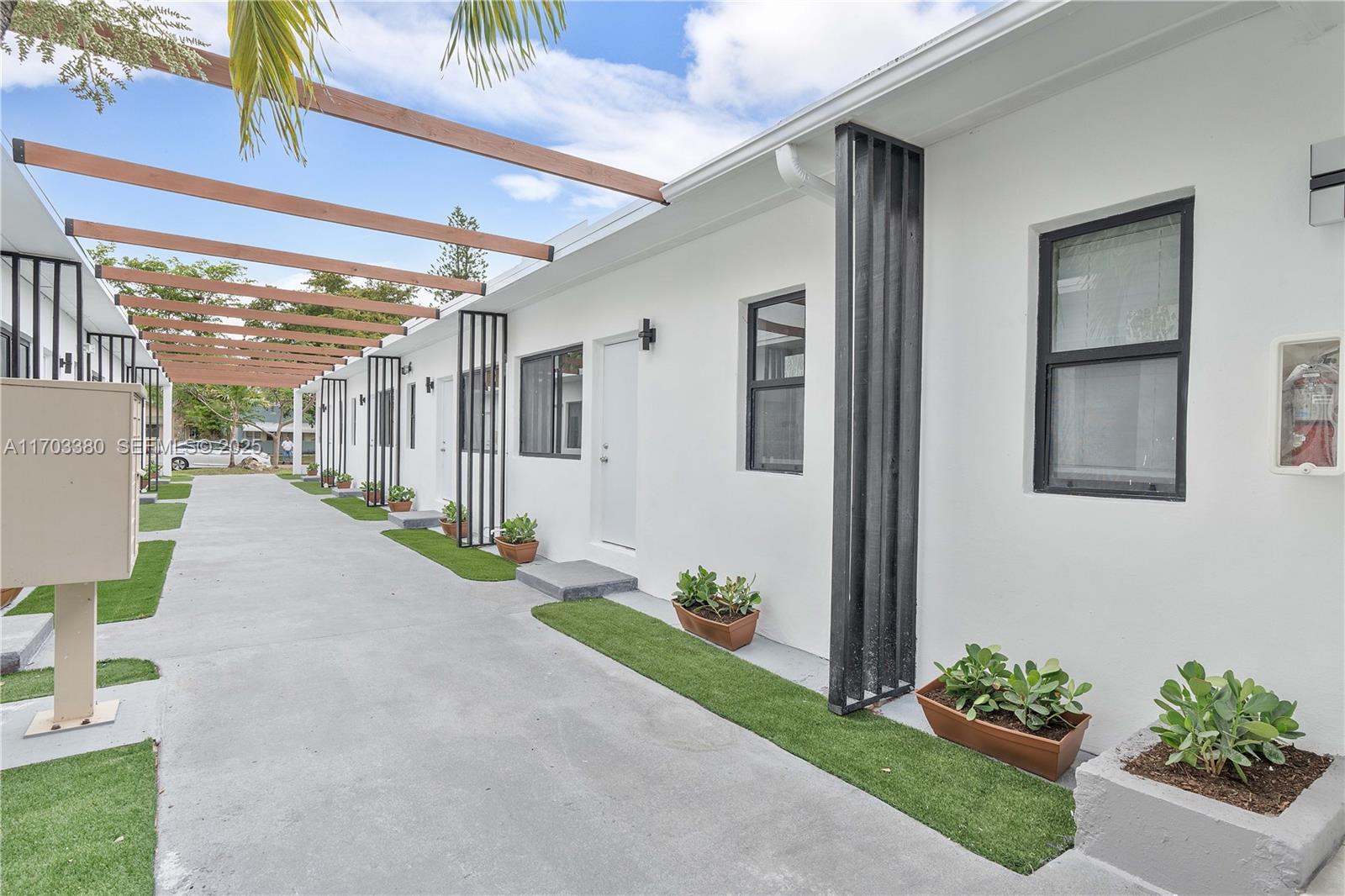 1946 Pierce Street, Unit 3 Hollywood, FL 33020 - Photo 13 of 43 a view of a porch with potted plants
